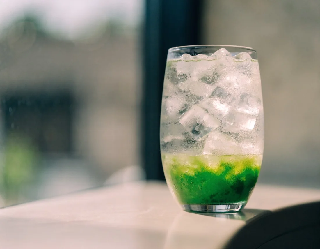 A matcha drink served over ice on a cafe menu