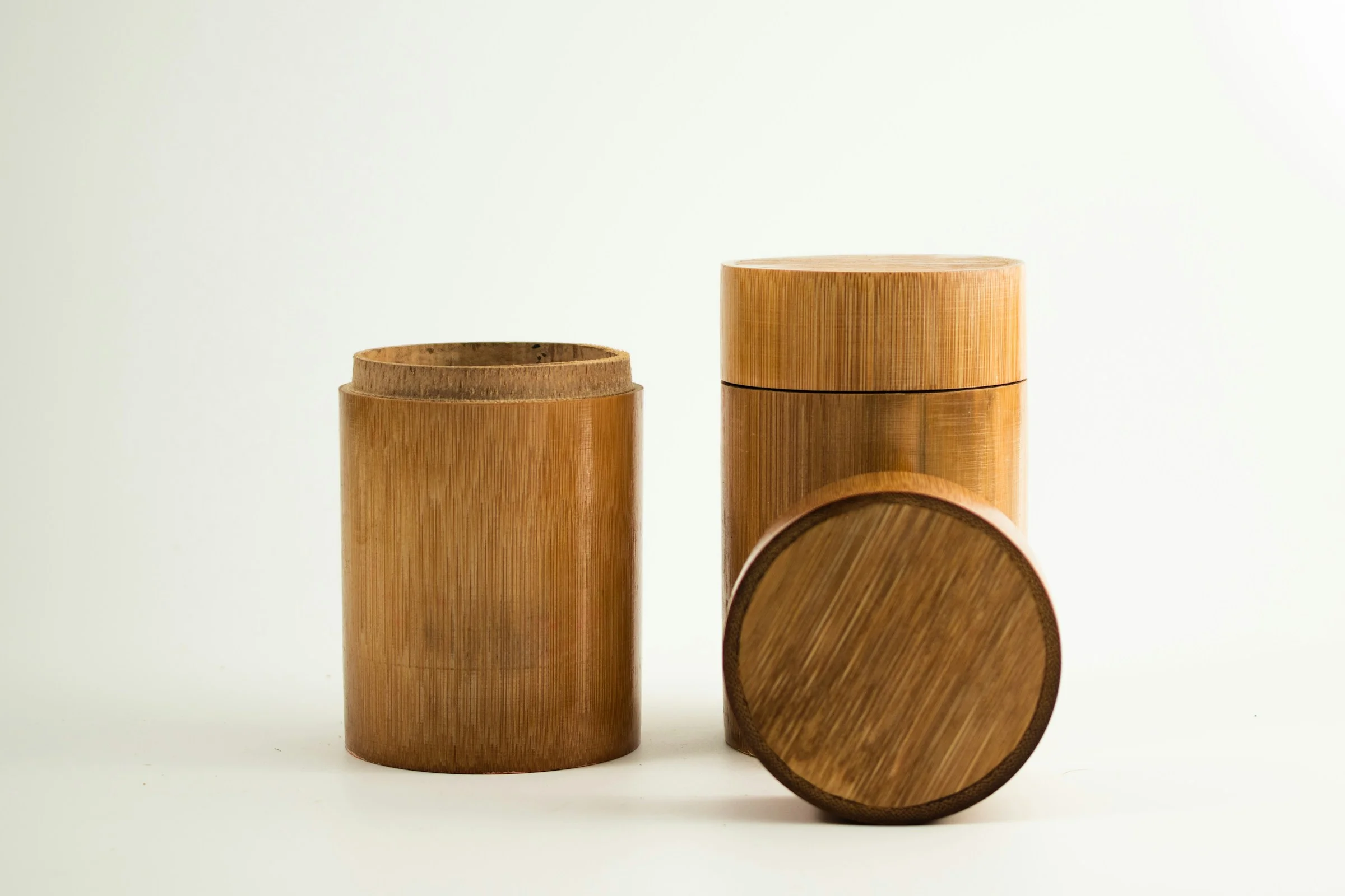 Two bamboo tea caddies, one opened and one sealed with its lid on
